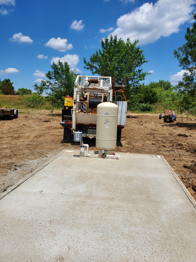 Newly installed pressure tank on a concrete pad